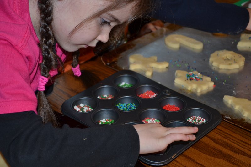 Muffin tins to control the mess and the amount of sprinkles "dumped" on each cookie. 